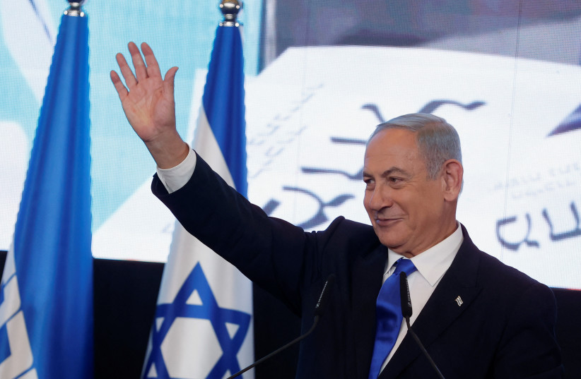  Likud party leader Benjamin Netanyahu waves as he addresses his supporters at his party headquarters during Israel's general election in Jerusalem, November 2, 2022. (photo credit: REUTERS/AMMAR AWAD)