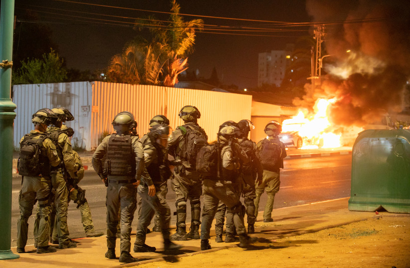  Israeli police seen on the streets of the central Israeli city of Lod, where synaogues and cars were torched as well as shops damaged, by Arab residents rioted in the city. May 12, 2021.  (photo credit: YOSSI ALONI/FLASH90)