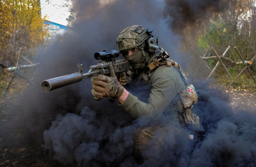  An instructor performs for participants, who take part in a military exercise for civilians conducted by members of the Ukrainian Volunteer Corps of the Right Sector near Lviv, Ukraine October 29, 2022. (photo credit: Mykola Tymchenko/Reuters)