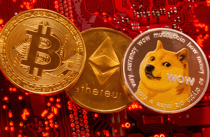 Representations of cryptocurrencies Bitcoin, Ethereum and DogeCoin are placed on PC motherboard in this illustration taken, June 29, 2021. (photo credit: REUTERS/DADO RUVIC/ILLUSTRATION/FILE PHOTO)