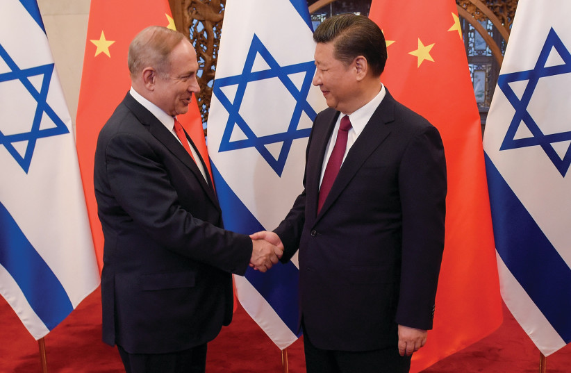  PRIME MINISTER Benjamin Netanyahu shakes hands with Chinese President Xi Jinping ahead of talks in Beijing, in 2017.  (photo credit: Etienne Oliveau/Reuters)