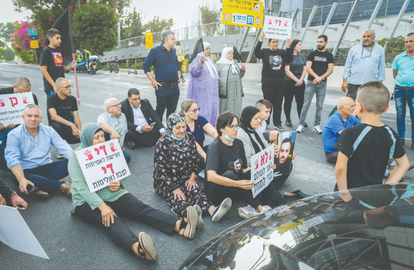  ISRAELI ARABS BLOCK a road as they protest against violence, organized crime and recent killings among their communities, in Tel Aviv, in 2021. (photo credit: AVSHALOM SASSONI/FLASH90)