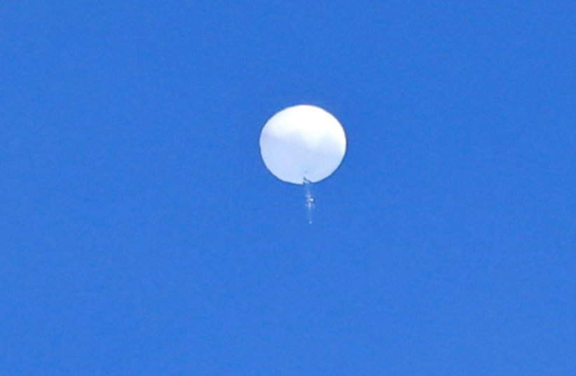  A suspected Chinese spy balloon is seen before it was shot down off the coast of Garden City, South Carolina, U.S. February 4, 2023 (photo credit: Travis Huffstetler/Handout via REUTERS)