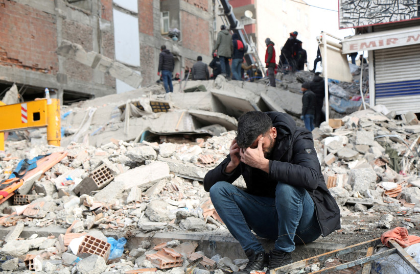  A man reacts at the site of a collapsed building in the aftermath of a deadly earthquake in Diyarbakir, Turkey February 8, 2023. (photo credit: REUTERS/SERTAC KAYAR)