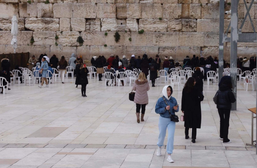 Women are seen walking across the Western Wall site in a photo taken February 9, 2023  (photo credit: MARC ISRAEL SELLEM/THE JERUSALEM POST)