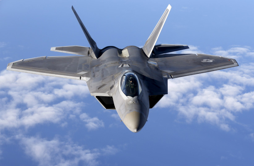 A F-22 Raptor fighter jet of the 95th Fighter Squadron from Tyndall, Florida approaches a KC-135 Stratotanker from the 100th Air Refueling Wing at the Royal Air Force Base in Mildenhall in Britain as they fly over the Baltic Sea towards the NATO airbase of Aemari, Estonia, September 4, 2015. (photo credit: REUTERS/WOLFGANG RATTAY)