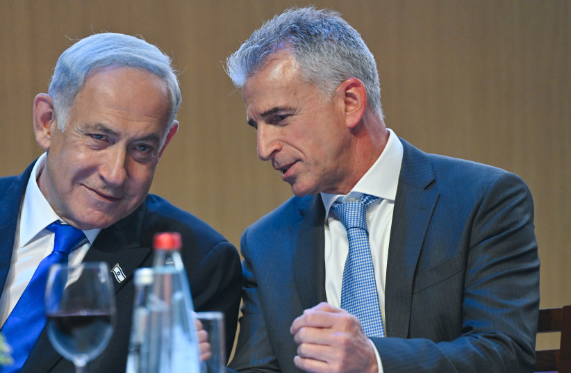  Israeli High Minister Benjamin Netanyahu is considered next to Mossad Director David Barnea at a pre-Passover toast, on April 4, 2023. (photo credit: KOBI GIDEON/GPO)