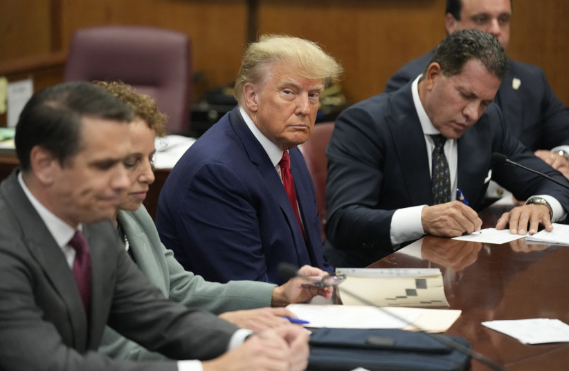  Former US President Donald Trump appears in court with members of his legal team for an arraignment on charges stemming from his indictment by a Manhattan grand jury following a probe into hush money paid to porn star Stormy Daniels, in New York City, US, April 4, 2023. (photo credit: REUTERS/SETH WENIG/POOL)