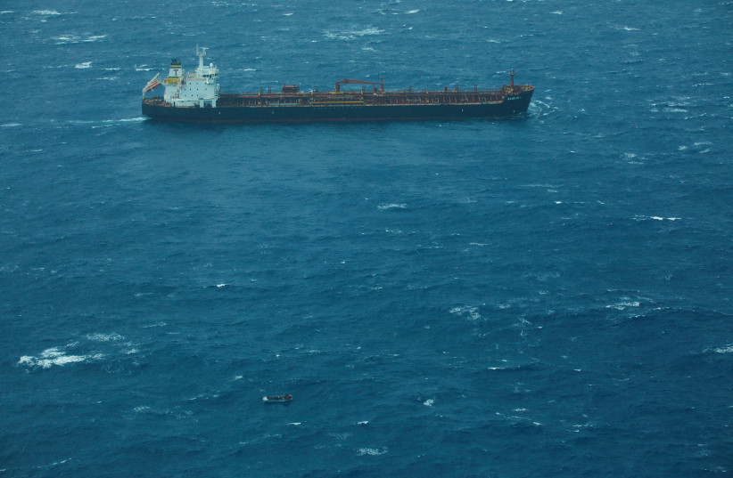  Aerial view shows the M/V BASILIS L merchant ship, which was ordered to help with rescue efforts of the migrant boat, in the absence of patrol boats from both Italy and Libya, which was en route from Libya in the central Mediterranean Sea March 11, 2023 (photo credit: Christian Ghodes/Sea-Watch.org/Handout via REUTERS )