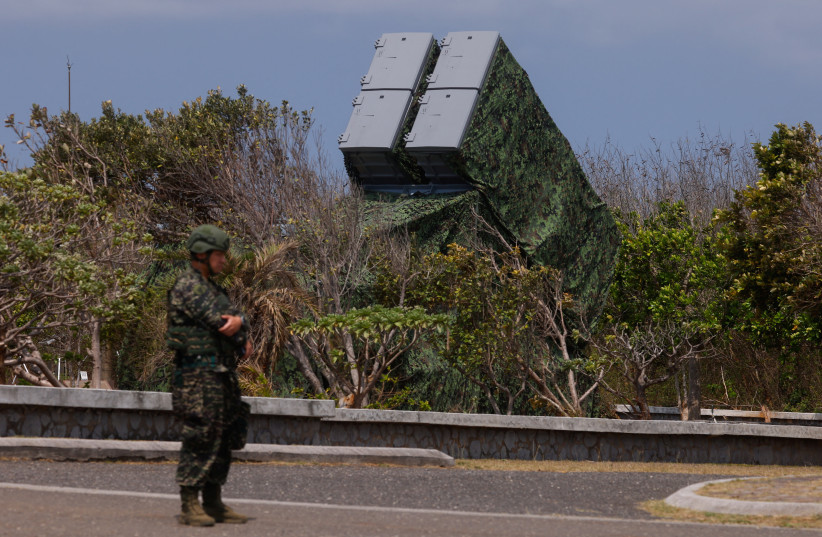  A soldier stands near Hsiung Feng mobile missile launchers at Cape Maobitou park in Pingtung County, Taiwan April 10, 2023. (photo credit: ANN WANG/REUTERS)