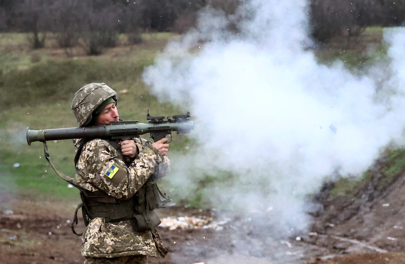  A Ukrainian serviceman with the "5 Separate Assault Brigade", fires an RPG on a training ground, amid Russia?s attack on Ukraine, in the region of Bakhmut, Ukraine, April 6, 2023. (photo credit: KAI PFAFFENBACH/REUTERS)