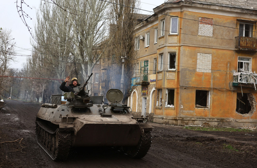 Ukrainian servicemen drive towards the frontline during heavy fighting at the frontline of Bakhmut and Chasiv Yar, in Chasiv Yar, Ukraine, April 12, 2023. (photo credit: REUTERS/KAI PFAFFENBACH)