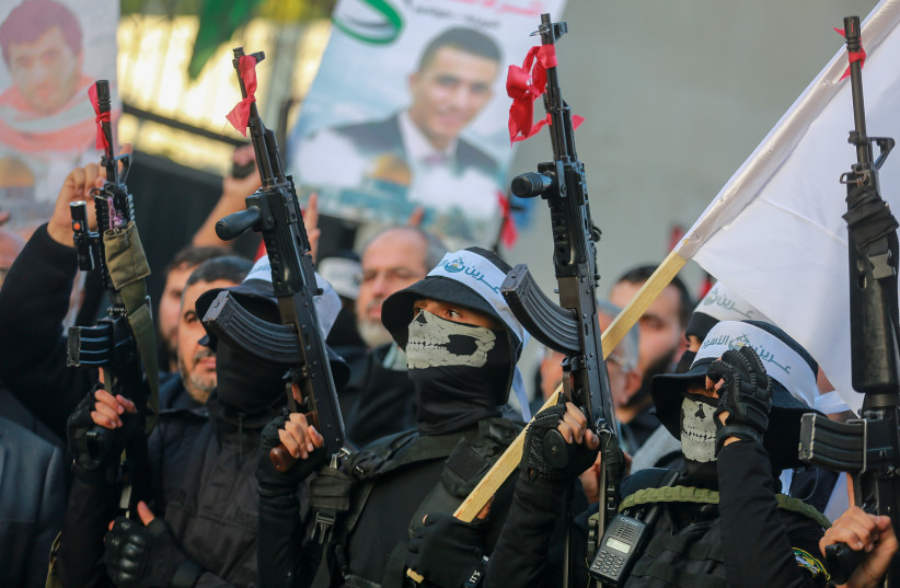  Palestinians Hamas militants wearing headbands reading "the Lion's Den", during a march in support of the group in Gaza City on December 10, 2022.  (photo credit: ATIA MOHAMMED/FLASH90)
