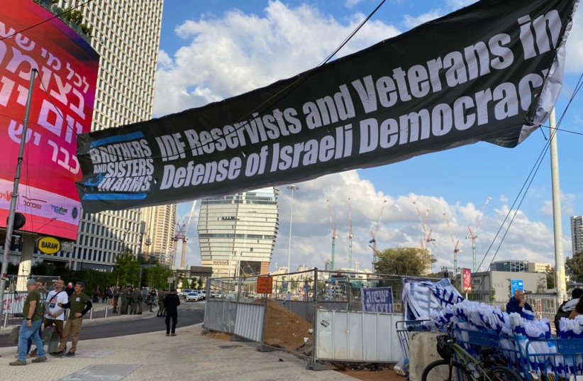  Brothers in Arms protesters prepare banners ahead of the weekly Saturday night judicial reform protests, April 29, 2023. (photo credit: AVSHALOM SASSONI/MAARIV)