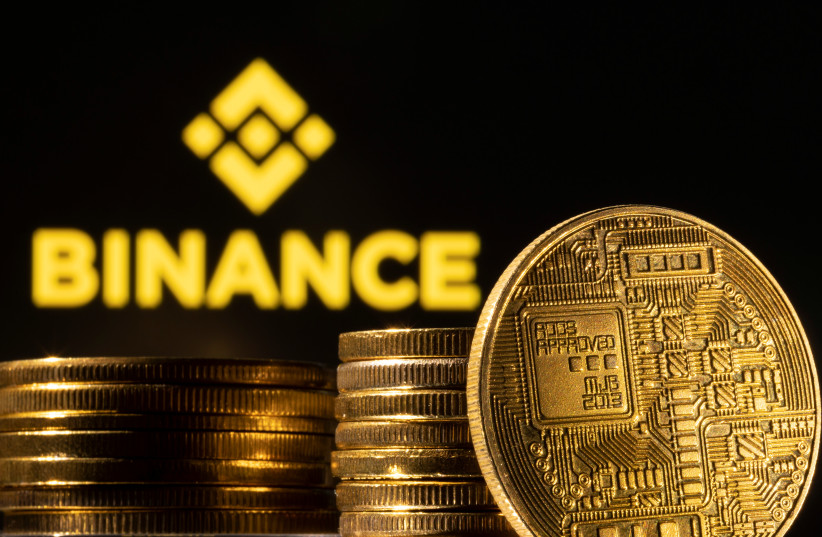  A representation of the cryptocurrency is seen in front of Binance logo in this illustration taken, March 4, 2022.  (photo credit: REUTERS/DADO RUVIC/ILLUSTRATION)