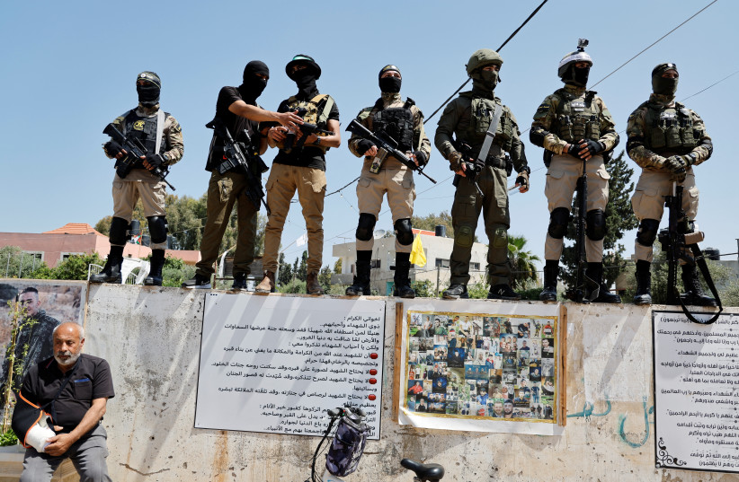  Gunmen stand during the funeral of two Palestinian Islamic Jihad gunmen who were killed in an Israeli raid, in Jenin refugee camp, in the West Bank May 10, 2023. (photo credit: RANEEN SAWAFTA/REUTERS)