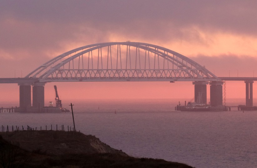  A general view shows a road-and-rail bridge, built to connnect the Russian mainland with the Crimean peninsula, at sunrise in the Kerch Strait, Crimea November 26, 2018. (photo credit: REUTERS/Pavel Rebrov/File Photo)