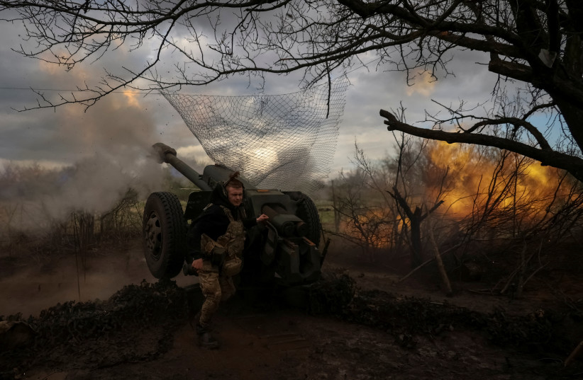  Ukrainian service members from a 3rd separate assault brigade of the Armed Forces of Ukraine, fire a howitzer D30 at a front line, amid Russia's attack on Ukraine, near the city of Bakhmut, Ukraine April 23, 2023.  (photo credit: REUTERS/SOFIIA GATILOVA)