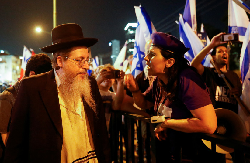  A person reacts during a march from Ramat Gan to the Ultra-Orthodox neighbourhood of Bnei Brak in protest against monetary demands by the Ultra-Orthodox community for the upcoming budget, in Bnei Brak east of Tel Aviv, Israel, May 17, 2023. (photo credit: CORINNA KERN/REUTERS)