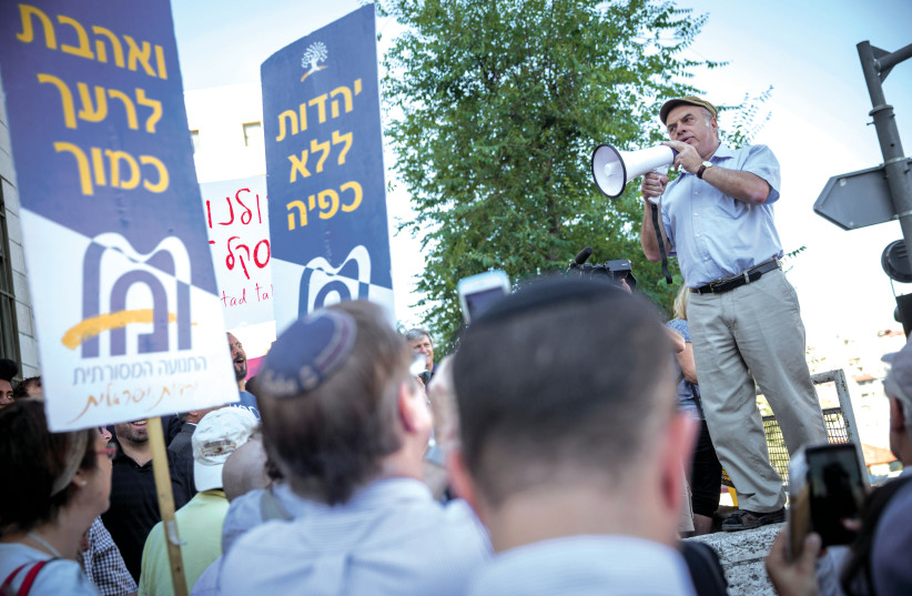  THEN-JEWISH AGENCY CHAIRMAN Natan Sharansky speaks at a protest held outside the Chief Rabbinate in Jerusalem, in 2016. The signs read ‘Love your neighbor as yourself’ and ‘Judaism without coercion.’ (photo credit: HADAS PARUSH/FLASH90)