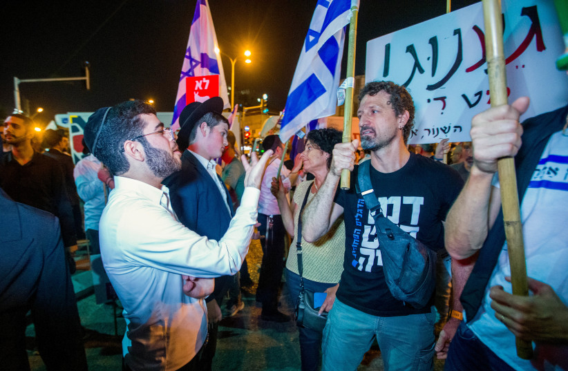  Demonstrators argue with Ultra orthodox jews during a protest march in Bnei Brak, against the billions in funds provided to ultra-Orthodox parties in the state budget, on May 17, 2023.  (photo credit: FLASH90)