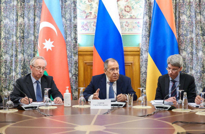 Russian Foreign Minister Sergei Lavrov and members of the delegation attend a meeting to defuse tensions between Azerbaijan and Armenia over the disputed territory of Nagorno-Karabakh, in Moscow, Russia, May 19, 2023. (photo credit: RUSSIAN FOREIGN MINISTRY/HANDOUT VIA REUTERS)