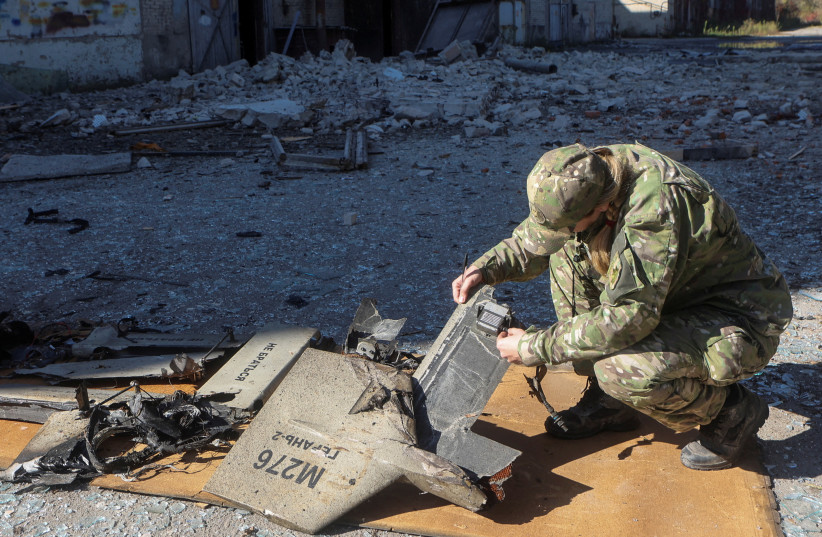  A police officer inspects parts of an unmanned aerial vehicle (UAV), what Ukrainian authorities consider to be an Iranian made suicide drone Shahed-136, at a site of a Russian strike on fuel storage facilities, amid Russia's attack on Ukraine, in Kharkiv, Ukraine October 6, 2022. (photo credit: REUTERS/VYACHESLAV MADIYEVSKYY)