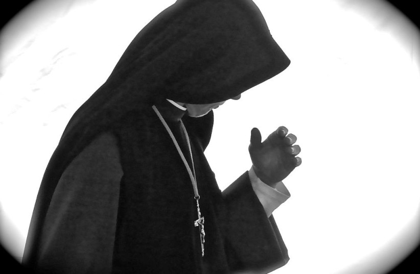  A Catholic nun is seen praying (Illustrative). (photo credit: Wikimedia Commons)
