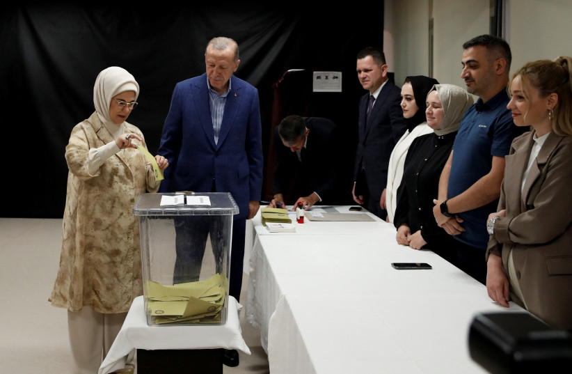 Turkish President Recep Tayyip Erdogan and his wife Emine Erdogan vote at a polling station during the second round of the presidential election in Istanbul, Turkey May 28, 2023.  (photo credit: Murad Sezer/Pool/Reuters)