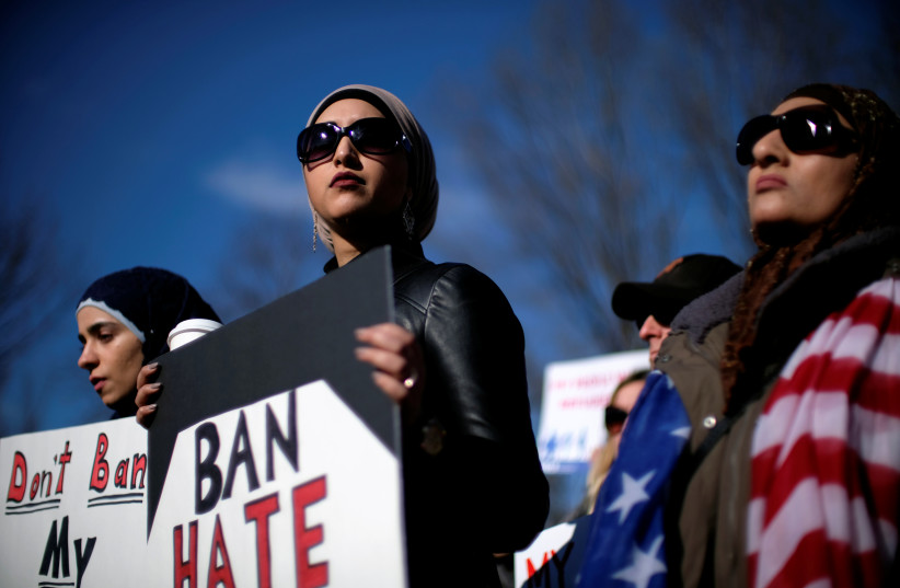  Activist groups including the Council on American-Islamic Relations, MoveOn.org, Oxfam, and the ACLU hold a rally in front of the White House to mark the anniversary of the first Trump administration travel and refugee ban in Washington, US, January 27, 2018. (photo credit: REUTERS/JAMES LAWLER DUGGAN)