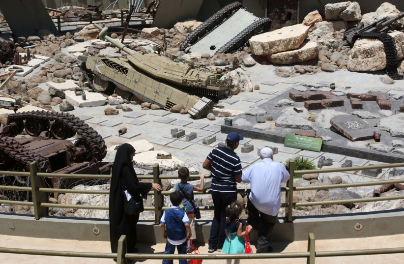 Visitors look at tanks left behind in Lebanon by Israeli forces as they visit the Hezbollah-run "Tourist Landmark of the Resistance" war museum in Mlita (aka Mleeta) in southern Lebanon on July 12, 2016. (photo credit: MAHMOUD ZAYYAT/AFP via Getty Images)