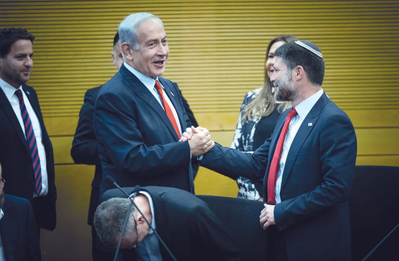  PRIME MINISTER Benjamin Netanyahu greets Finance Minister and Minister in the Defense Ministry Bezalel Smotrich in the Knesset, last week. (photo credit: YONATAN SINDEL/FLASH90)
