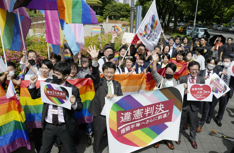 People including plaintiffs' lawyers hold banners and flags, after the lower court ruled that not allowing same-sex marriage was unconstitutional, outside Nagoya district court, in Nagoya, central Japan, May 30, 2023 (photo credit: REUTERS)