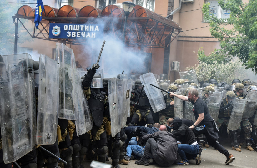  NATO Kosovo Force (KFOR) soldiers clash with local Kosovo Serb protesters at the entrance of the municipality office, in the town of Zvecan, Kosovo, May 29, 2023. (photo credit: REUTERS)