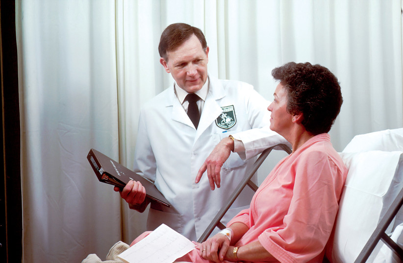 A doctor is seen tending to a patient (Illustrative). (photo credit: National Cancer Institute/Unsplash)