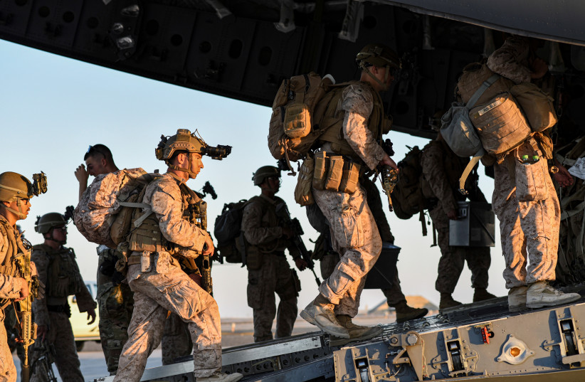US Marines load onto a U.S. C-17 Globemaster from McGuire Air Force Base to be transported to Afghanistan from Ali Al Salem Air Base, Kuwait August 18, 2021. Picture taken August 18, 2021 (photo credit:  Staff Sgt. Ryan Brooks/US Air Force/Handout via REUTERS)
