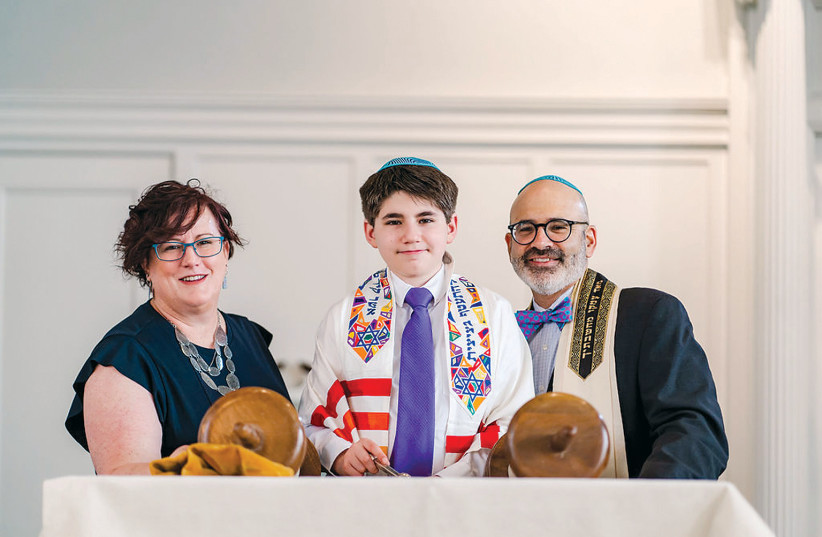  Rabbi Lewis and his wife, Jennifer, celebrating with their son Eden as he became bar mitzvah on June 12, 2021. (photo credit: COURTESY RABBI LEWIS)