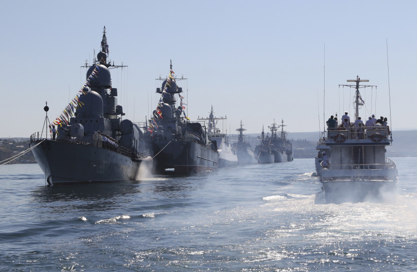  Russian warships are seen during a rehearsal for the Navy Day parade in Sevastopol, Crimea, July 24, 2015. Russia will mark Navy Day on July 26. (photo credit: PAVEL REBROV/REUTERS)