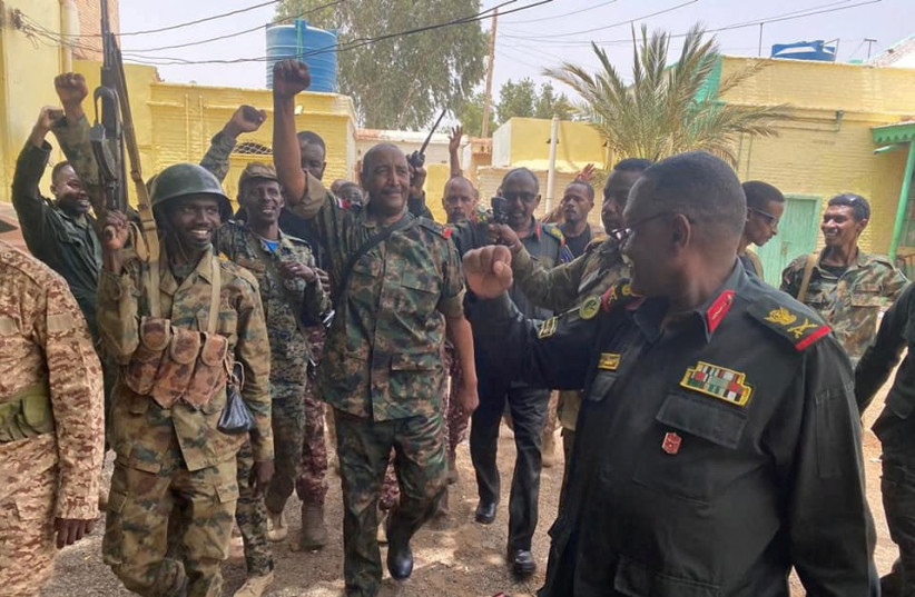  Sudan's General Abdel Fattah al-Burhan walks with troops,in an unknown location, in this picture released on May 30, 2023. (photo credit: Sudanese Armed Forces/Handout via REUTERS)