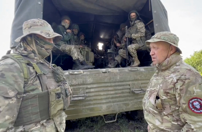  Founder of Wagner private mercenary group Yevgeny Prigozhin speaks with servicemen during withdrawal of his forces from Bakhmut in an unidentified location, Russian-controlled Ukraine, in this still image taken from video released June 1, 2023. (photo credit: PRESS SERVICE OF "CONCORD"/HANDOUT VIA REUTERS)