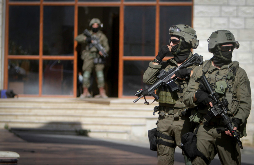  Israeli soldiers search the West Bank village of Qafin for the suspected gunmen who shot and killed an Israeli civilian near the entrance to a Jewish settlement of Hermesh, May 30, 2023 (photo credit: NASSER ISHTAYEH/FLASH90)