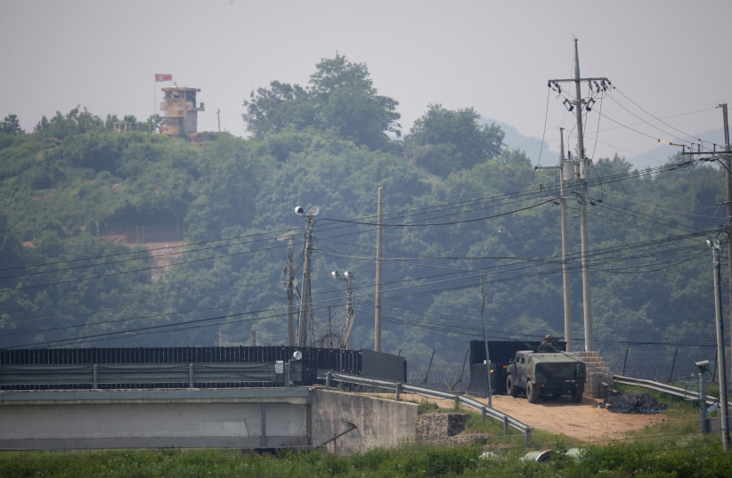 A South Korean soldier in an armoured vehicle stands guard as a North Korean guard post is seen in this picture taken near the demilitarized zone which separates the two Koreas in Paju, South Korea, May 31, 2023. (photo credit: KIM HONG-JI/ REUTERS)