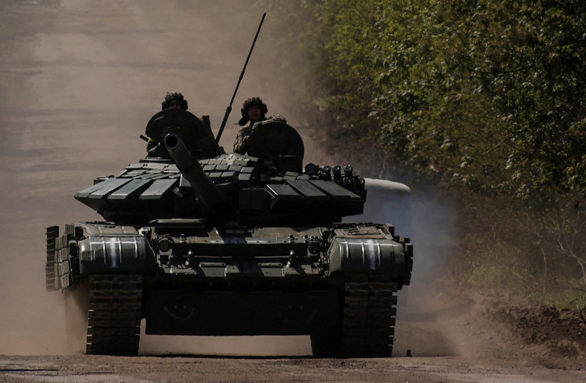  Ukrainian servicemen ride atop of a tank on a road to the frontline town of Bakhmut, amid Russia's attack on Ukraine, in Donetsk region, Ukraine May 12, 2023.  (photo credit: REUTERS/Sofiia Gatilova/File Photo)