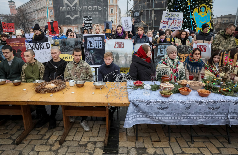  Relatives and supporters of Ukrainian prisoners of war (POWs) from of the Azov regiment attend a performance named "Azov regiment Christmas in captivity" demanding to speed up their release from a Russian captivity, amid Russia's attack on Ukraine, at the Independence Square in Kyiv, Ukraine Decemb (photo credit: GLEB GARANICH/REUTERS)