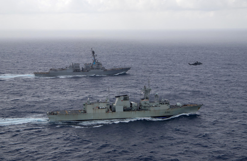  U.S. Navy guided-missile destroyer USS Chung-Hoon sails alongside the Royal Canadian Navy frigate HMCS Montreal during Surface Action Group operations as a part of exercise “Noble Wolverine" in the South China Sea May 30, 2023. (photo credit:  US Navy/Naval Air Crewman (Helicopter) 1st Class Dalton Cooper/Handout via REUTERS)