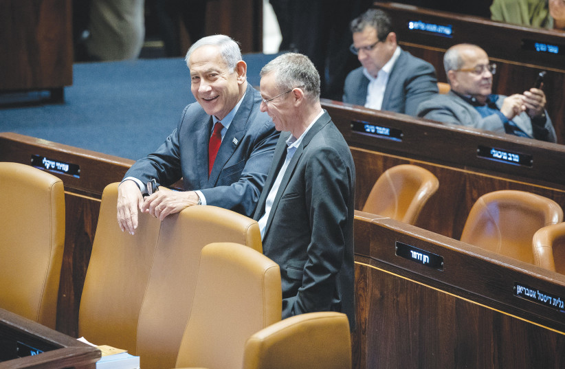 PRIME MINISTER Benjamin Netanyahu and Justice Minister Yariv Levin enjoy a light moment in the Knesset plenum (photo credit: YONATAN SINDEL/FLASH90)