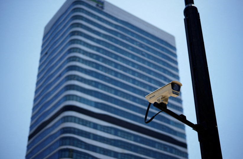  A surveillance camera is seen in front of an office building, where the office of Capvision is located, in Shanghai (photo credit: REUTERS)