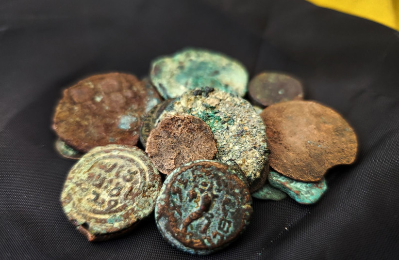  Ancient coins, including one from the reign of the last Jewish king, Antigonus II Mattathias, are seen after having been recovered from an alleged thief in eastern Jerusalem. (photo credit: Israel Antiquities Authority)