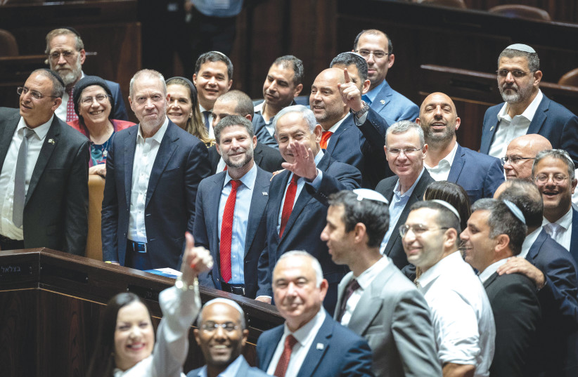  PRIME MINISTER Benjamin Netanyahu, cabinet ministers and coalitin MKs celebrate the passage of the state budget in the Knesset plenum, last month. (photo credit: YONATAN SINDEL/FLASH90)