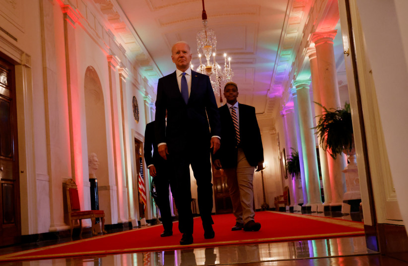  U.S. President Joe Biden and LGBTQ advocate Ashton Mota of the GenderCool Project walk before delivering remarks to commemorate LGBTQ+ Pride Month in the White House, Washington, U.S., June 25, 2021. (photo credit: REUTERS/JONATHAN ERNST)